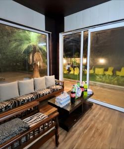 a living room with a couch and a large window at The Casa Bella in Faridabad