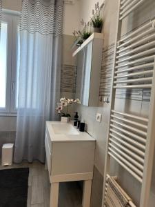 a white bathroom with a sink and a window at Casa RAFAEL & GINEVRA in Stazzano +28 photos