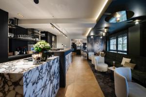 a bar in a restaurant with white chairs at Manoir Kasselslay in Roder