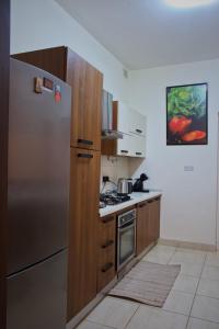 a kitchen with a stainless steel refrigerator and wooden cabinets at 11 St Joseph in Birgu