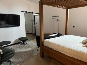 a bedroom with a bed and a flat screen tv at chez Jess chambre d'hôte a UZES in Uzès +1 photo