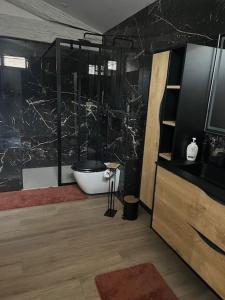 a bathroom with a bath tub and a sink at chez Jess chambre d'hôte a UZES in Uzès