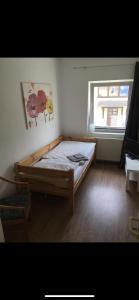 a bedroom with a bed in a room with a window at Pension am Markt Luckenwalde in Luckenwalde