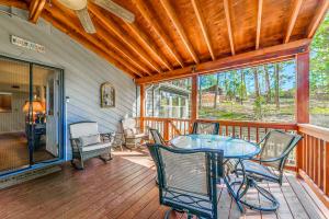 a porch with a table and chairs on a deck at North Street Escape in Ruidoso