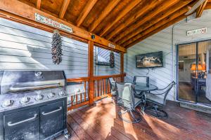 a kitchen with a stove and a table on a porch at North Street Escape in Ruidoso