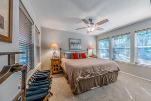 a bedroom with a bed and a ceiling fan at North Street Escape in Ruidoso