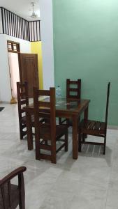 a dining room with a table and chairs and a table and chairs at East villa in Kalmunai