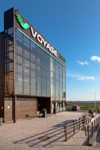 a building with a sign on the side of it at Voyage Hotel in Saint Petersburg