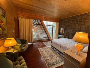 a bedroom with a bed and a living room at Alpine Home By HespakBNB in Dunga Gali