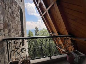 a balcony with a window with a view at Alpine Home By HespakBNB in Dunga Gali