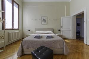 a bedroom with a bed and a chair in it at TONIOLO VENICE ROOMS in Mestre