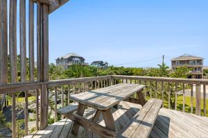 a wooden picnic table on the deck of a house at HISA14: Sunny Daze in Salvo