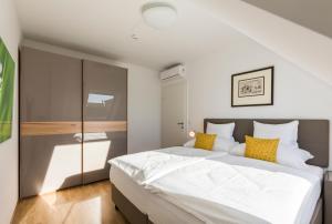 Кровать или кровати в номере Vienna Grand Apartments City