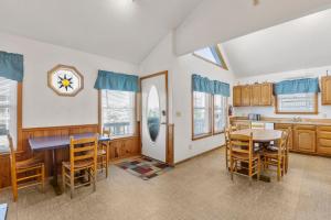 a kitchen and dining room with a table and chairs at HISA14: Sunny Daze in Salvo