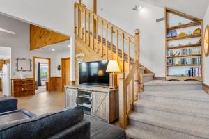 a living room with a staircase and a tv at HISA14: Sunny Daze in Salvo