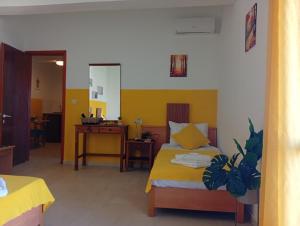 a bedroom with a bed and a desk in it at on the STRIP apartment 4 in Kavos