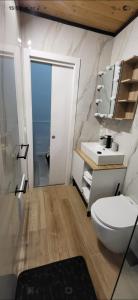 a bathroom with a toilet and a sink at Renova7io sweet home Napoli in Naples