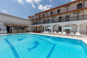 a large swimming pool in front of a building at on the STRIP apartment 4 in Kavos