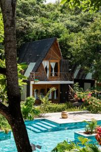 a house with a pool in front of it at Sambe Manglar in Moñitos