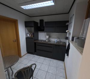 a kitchen with a sink and a counter top at FeWo zum Der Hilderser in Hilders