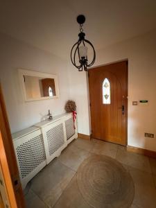 a bathroom with a sink and a wooden door at Beech House in Antrim