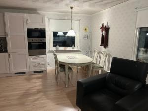 a kitchen and dining room with a table and chairs at Kukkolaforsen 160 in Haparanda +10 photos