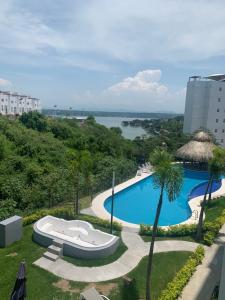 a view of a swimming pool and a resort at Hermoso departamento en Tequesquitengo alberca jacuzzi y acceso al lago in Tequesquitengo