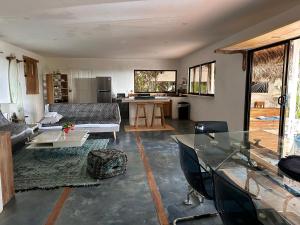a living room with a couch and a table at La Sana Surf Hotel, Playa Carmen in Santa Teresa Beach