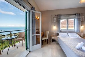 a bedroom with a bed and a view of the ocean at Pension Elena in Ágios Nikólaos +132 photos