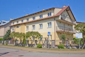 a large building on the side of a street at Willa Irena in Karwia