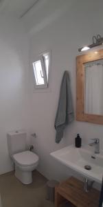 a white bathroom with a toilet and a sink at Maria's Private Space - Mykonos in Ano Mera