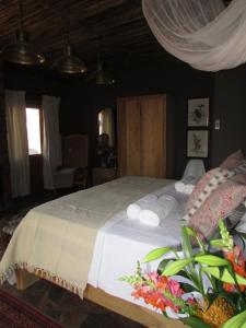 a bedroom with a bed with rolled towels on it at Kukama's Rest at Zebula 317 in Mabula