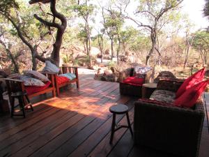 a porch with couches and chairs on a wooden deck at Kukama's Rest at Zebula 317 in Mabula