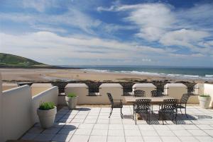 a patio with a table and chairs and a beach at 3 Bed in Croyde oc-spind in Croyde