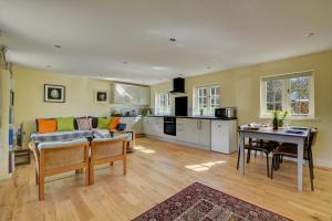 a kitchen and living room with a couch and a table at 1 Bed in Northrepps oc-1736 in Northrepps