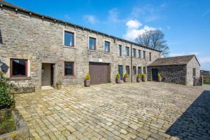 an old stone building with a brick driveway at 2 Bed in Cowling oc-ds238 in Cowling
