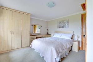 a white bedroom with a large bed and a mirror at 2 Bed in Cowling oc-ds238 in Cowling