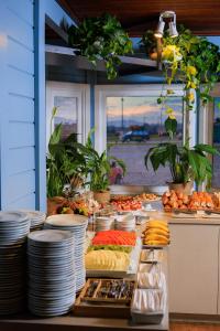 a buffet with plates and food on a table at Hotel 10 Itajai/Navegantes in Itajaí