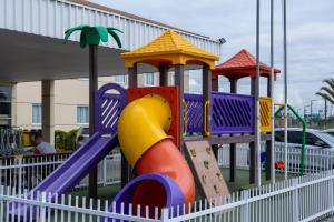 a playground with a slide in front of a building at Hotel 10 Itajai/Navegantes in Itajaí