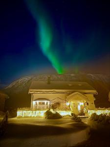 a house with the aurora in the sky at Close to nature - FREE PARKING in Tromsø