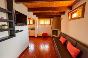 a living room with a couch and a television at Casa do Olival in Macedo de Cavaleiros +22 photos
