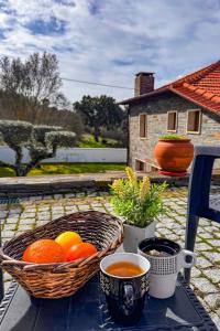 a table with two baskets of fruit on a balcony at Casa do Olival in Macedo de Cavaleiros