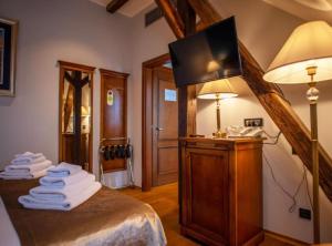 a bedroom with a bed with a tv on top of it at Jurjevec Castle in Brežane Lekeničke