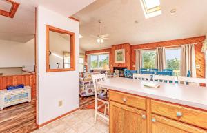 a kitchen and dining room with a table and chairs at Misty Blue - Corolla, Ocean Sands, 200 Yards to Beach, Ocean View, Pets OK, Flex Stays Year Rnd in Corolla