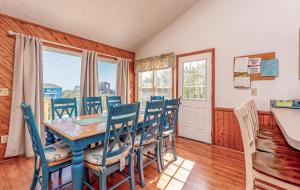 a dining room with a table and chairs at Misty Blue - Corolla, Ocean Sands, 200 Yards to Beach, Ocean View, Pets OK, Flex Stays Year Rnd in Corolla