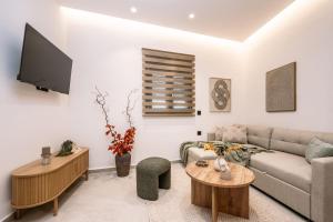a living room with a couch and a tv at Alavastros City Center in Zakynthos