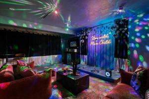 a room with a stage with couches and a table at Rockaway Mesa Dome Views Pool Karaoke Sauna in Yucca Valley +60 photos