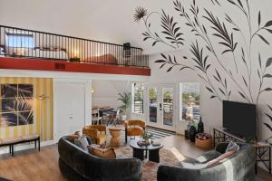 a living room with couches and a tv at Rockaway Mesa Dome Views Pool Karaoke Sauna in Yucca Valley