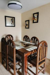 a dining room with a table and six chairs at Casa Paraíso in Ixtapa