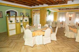 a dining room with a table and white chairs at Hotel Don Manuel in Ronda +53 photos
